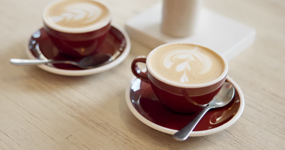 Coffee, cream and espresso in cafe for drink, caffeine beverage or cappuccino foam. Latte art, creative or warm tea in mug with liquid for restaurant, shop or diner for order, small business or date