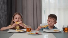 siblings sitting together at dining table eating pizza with berry juice in glass cups smiling at each other during cozy indoor meal with soft natural light filtering through - Powered by Shutterstock - Get 15% off with code: PIKWIZARD15