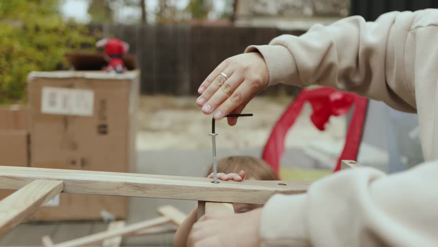 A child is actively engaged in a fun and creative DIY project with the guidance of an adult