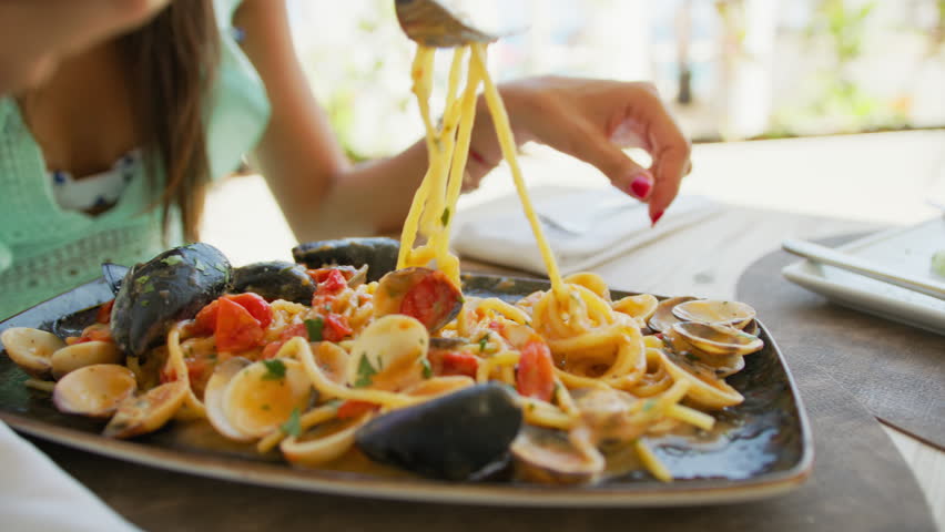 Spaghetti With Mussels And Clams Eaten By A Woman Having Lunch At The Resort 