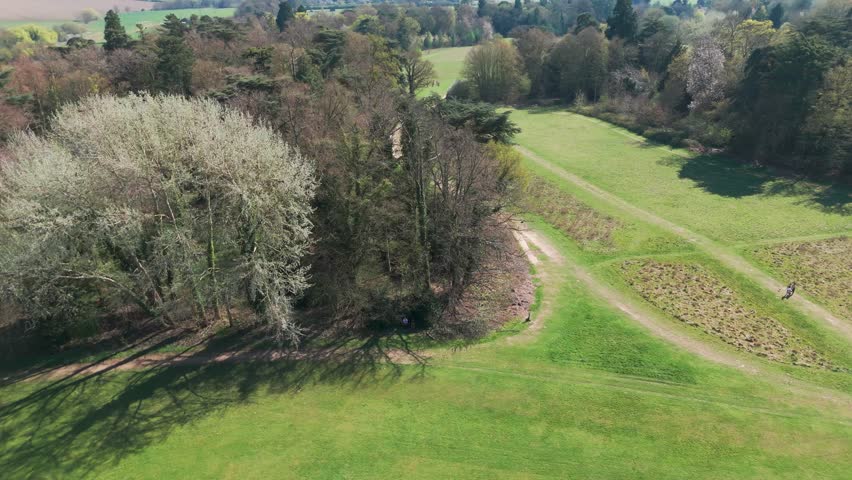 Nowton park in bury st. edmunds with trees, pathways, and green fields , aerial view