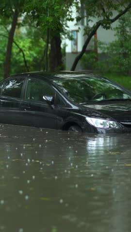 Flooded cars on the street of the city. Street after heavy rain. Water could enter the engine, transmission parts or other places. Disaster Motor Vehicle Insurance Claim Themed. Severe weather concept