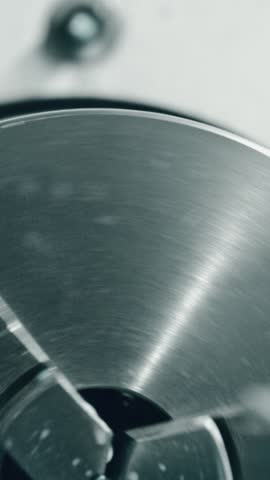 Cnc machine cutting metal with precision and coolant spray, creating intricate parts in a high-tech manufacturing process. Close-up of automated machining with spinning cutter