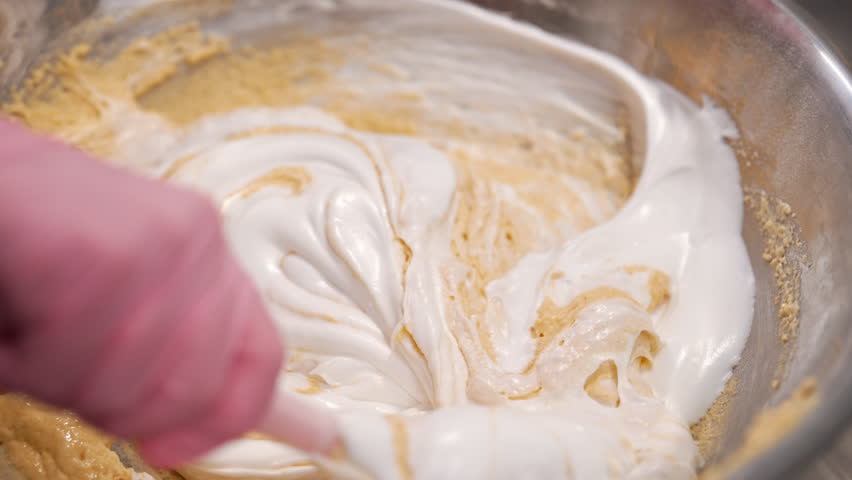 Pastry chef mixes dough, baking sponge cake. Confectioner woman working kitchen