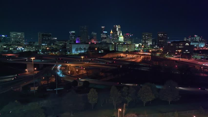 Hyperlapse drone of traffic on overpass highway and interstate in downtown of Atlanta, Georgia. Night scene with lighting skyline and Skyscrapers. Wide shot.