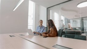 Two innovative professionals in a dynamic office engage in a brainstorming session, highlighting how embracing team diversity boosts productivity and helps achieve shared goals efficiently - Powered by Shutterstock - Get 15% off with code: PIKWIZARD15