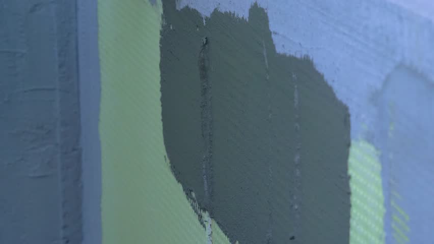 External wall insulation system EWIS. Thermally insulated, protective exterior cladding procedure use of expanded polystyrene, topped off plaster