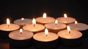 Eight tealight candles glowing warmly in the dark creating a calm and tranquil atmosphere perfect for reflection or celebration. - Powered by Shutterstock - Get 15% off with code: PIKWIZARD15