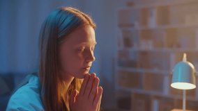 Young woman with Folded Hands Praying Quietly at Night, Peaceful Face in Soft Evening Light, Moment of Deep Faith, Hope, Spirituality and Mindfulness, Seeking Inner Peace and Personal Reflection. - Powered by Shutterstock - Get 15% off with code: PIKWIZARD15