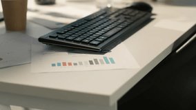 Modern workspace with analytical data paperwork documents in bright office environment with potted plants. Tablet on desk with digital statistics charts displayed on screen, close up shot - Powered by Shutterstock - Get 15% off with code: PIKWIZARD15