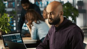 Happy man in office reviewing financial graphs, pleased after seeing good key performance indicators. Cheerful employee celebrating positive KPIs and data trends, camera A - Powered by Shutterstock - Get 15% off with code: PIKWIZARD15