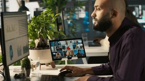 Worker in office talking with colleagues during internet videocall. Employee at work discussing with business partners during remote teleconference meeting, analyzing metrics, camera A - Powered by Shutterstock - Get 15% off with code: PIKWIZARD15