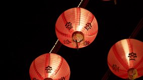 Red Chinese lanterns sway gently as night winds pass through them outdoors - Powered by Shutterstock - Get 15% off with code: PIKWIZARD15