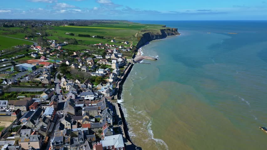 Arromanches-les-Bains village, Normandy cliffs coastline, historic D-Day site, France. Aerial drone panoramic view