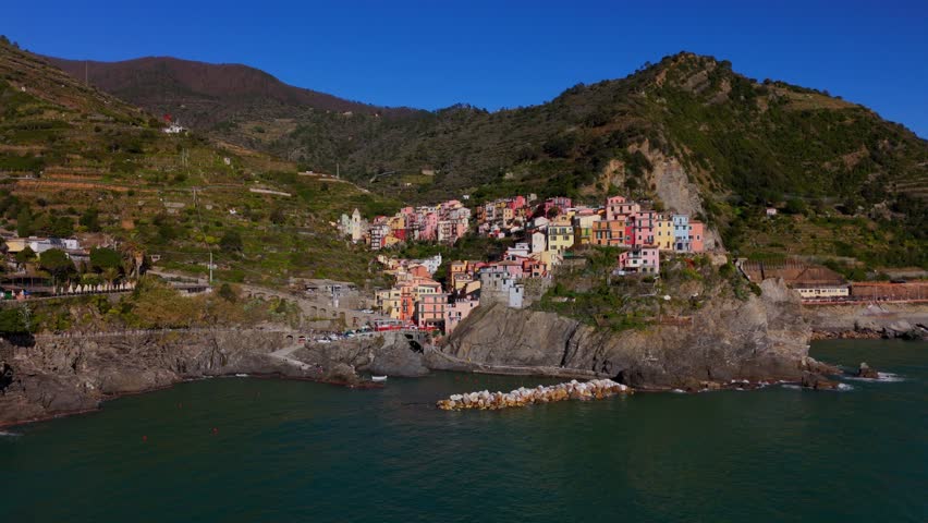 Colorful cliffside houses in Manarola, Cinque Terre, Italy, seen from above on a clear day