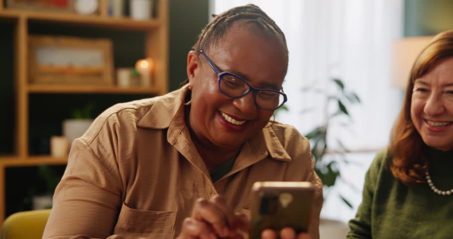 Phone, search and senior women with glasses in house reading social media, joke or funny reel and comic gif. Smartphone, help or friends showing how to, sign up or subscription service while bonding