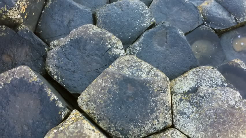 Slow camera movement across hexagonal basalt formations at Giant