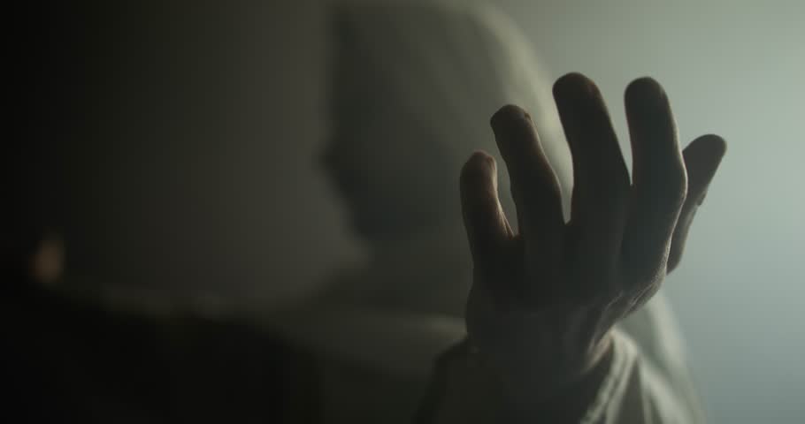Jesus Christ, prophet, or biblical figure in prayer and worship with hands lifted in glowing, ambient holy light. Perfect for Easter resurrection visual.