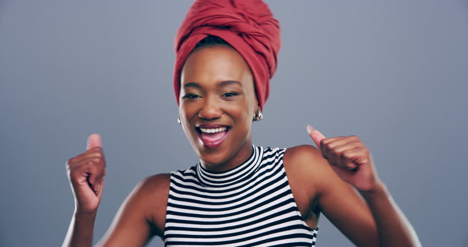 Face, dance and black woman with celebration, excited and motivation on a grey studio background. Portrait, African person and model with energy, wow and cheerful with achievement, success and joy