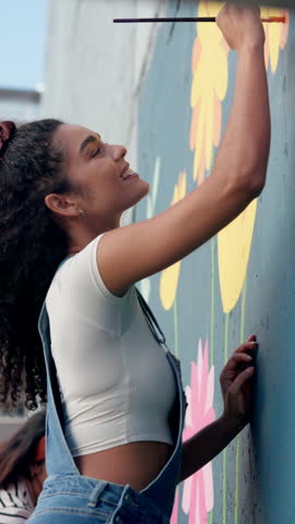 Happy woman, painter or creativity with wall art for project, design or colorful painting at school. Female person, volunteer or artist with smile, paintbrush or mural activity for community service