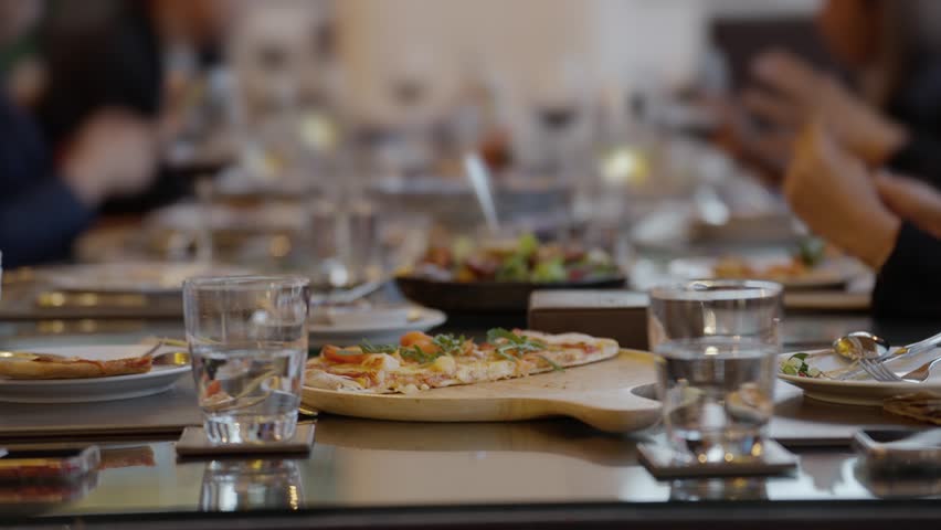 Businesspeople eating dining on banquet table, The setup for business networking dinner in elegant hotel setting for gatherings, Corporate event with diverse food options and attendees enjoying
