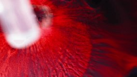 Dark red fluid dispersing in black liquid, macro shot of chemical reaction or ink mix - Powered by Shutterstock - Get 15% off with code: PIKWIZARD15