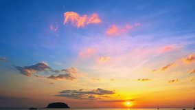 Time lapse view of A serene seascape capturing colorful of sunset over a calm ocean, with a small island against the vibrant sky and gentle waves reflecting the last light of day. Kata beach Phuket - Powered by Shutterstock - Get 15% off with code: PIKWIZARD15