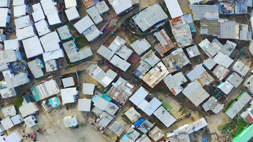 Drone, township and poor community or rural infrastructure, development and third world settlement. Aerial, neighborhood and poverty or village, outdoors and dirt in environment or project housing