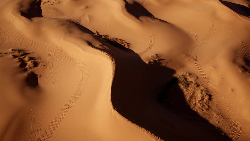 A bird’s-eye view reveals the enchanting shapes and rich colors of pink sand dunes in southern Utah.