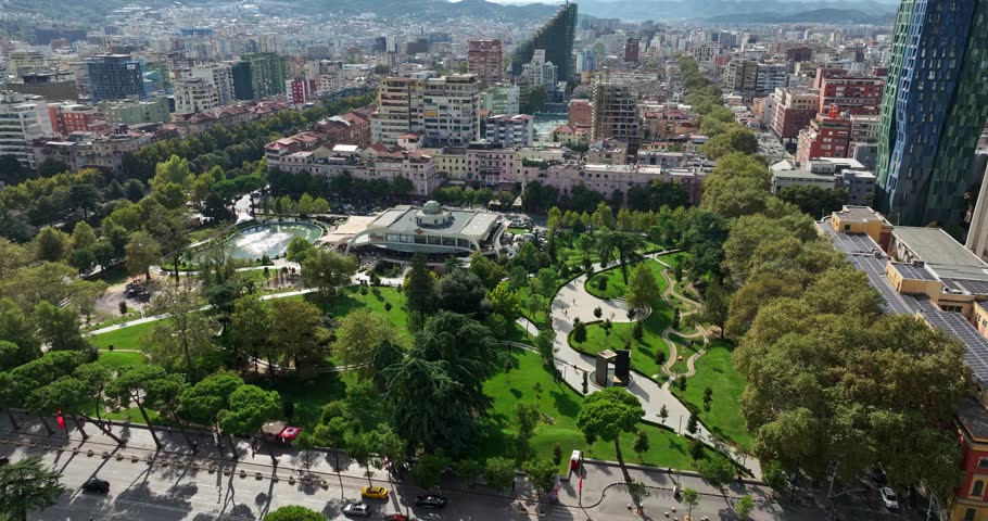 Tirana cityscape with modern buildings, urban fabric and lush green spaces and fountains at Grand Park, Albania