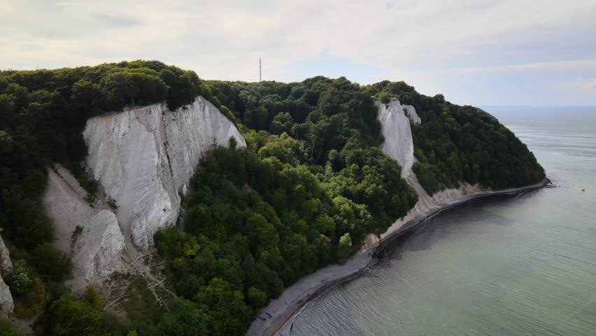 Aerial drone view of Rügen’s famous Königsstuhl chalk cliffs, where white rock meets lush forest and calm Baltic waters.