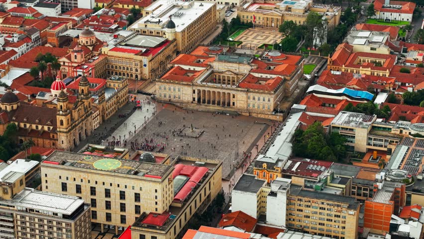 Aerial orbit establishing in telephoto of the Bolivar square and the national capitol of Colombia, Bogota, tourist district of La Candelaria.