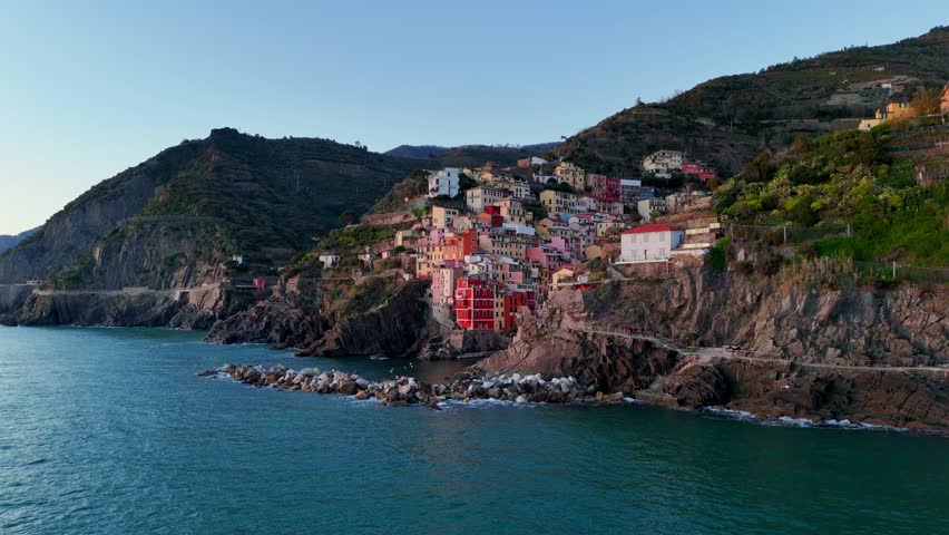 Colorful coastal town at sunset, aerial view of Riomaggiore, Cinque Terre, Italy
