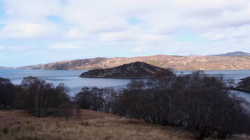 Rugged Scottish landscape view overlooking loch lake of water amongst mountains in highlands of Scotland UK