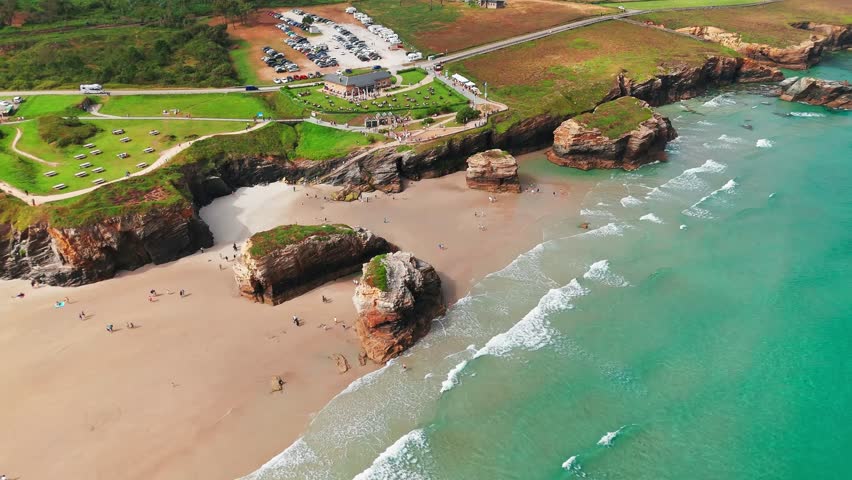 Amazing aerial view of the Playa de Las Catedrales beach in Galicia region at sunset, northern Spain. Beautiful cliff formations on famous Cathedral Beach, Cantabrian Coast 