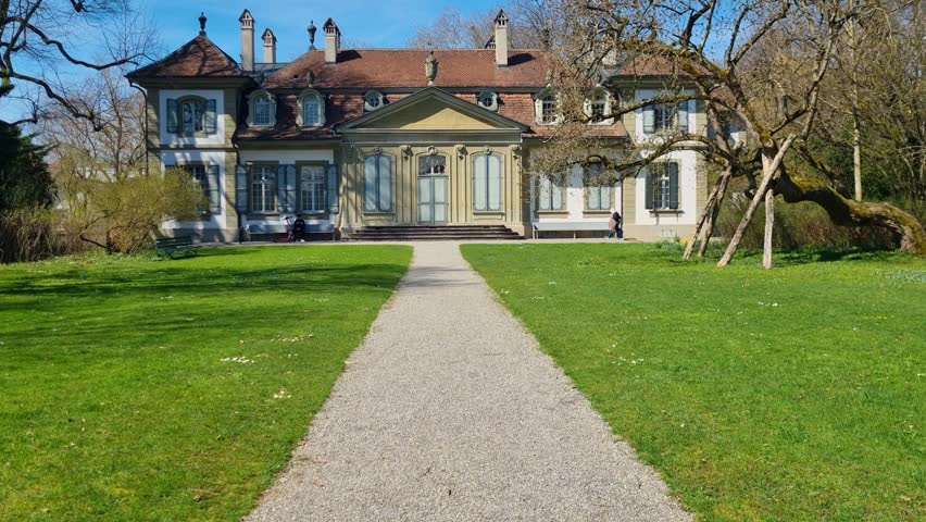 Shot of the historic Schloss Bümpliz on a bright spring day, showcasing the impressive architecture and serene surroundings. Located in Bern, Switzerland, it is a prime example of medieval history