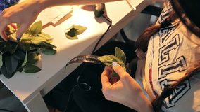 Artistic floral crafting with detailed focus on arranging green leaves by hand - Powered by Shutterstock - Get 15% off with code: PIKWIZARD15