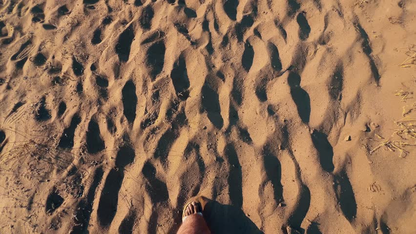 walking through the yellow orange small sand desert under neon sky
