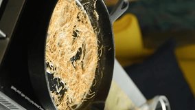 Vertical video. Adding rice to the vermicelli in the pan. Stage of preparing pilaf. - Powered by Shutterstock - Get 15% off with code: PIKWIZARD15