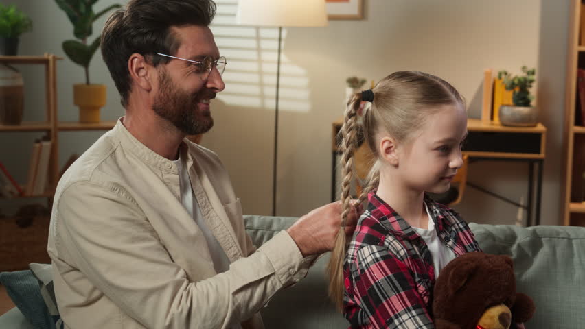 Family father Caucasian man dad caring little lovely adorable child girl braiding healthy hair daughter kid hairstyle hairdo beauty routine at home adopted custody love bonding parenting childcare - Powered by Shutterstock - Get 15% off with code: PIKWIZARD15