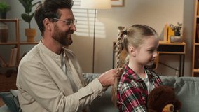 Family father Caucasian man dad caring little lovely adorable child girl braiding healthy hair daughter kid hairstyle hairdo beauty routine at home adopted custody love bonding parenting childcare - Powered by Shutterstock - Get 15% off with code: PIKWIZARD15