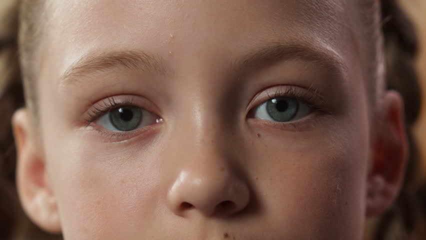 Cropped view child face serious close up eyes kid daughter little girl looking at camera healthy eye health look see indoors watching emotion toddler childhood custody adoption pediatric medicine