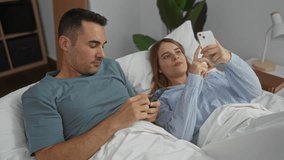 Couple in bed using smartphones, man and woman smiling together in cozy bedroom with indoor greenery, relaxed and happy atmosphere inside a modern home setting - Powered by Shutterstock - Get 15% off with code: PIKWIZARD15