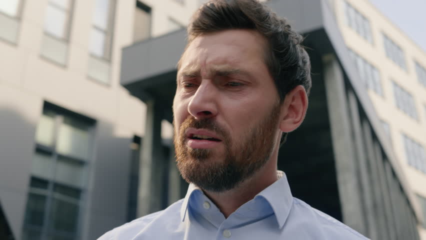Upset sad failure anxiety male near office read bad news receive message reject bank notification problem lost job failure headache in city Caucasian man business guy businessman using mobile phone