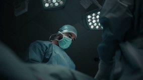 Low angle shot of a Surgeon Performing Operation Under Bright Surgical Lights in Modern Hospital - Powered by Shutterstock - Get 15% off with code: PIKWIZARD15