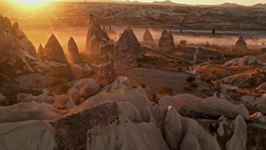 "Horseback Riding Group Touring Cappadocia Terrain at Sunset"