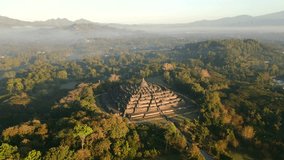 Aerial view of ancient Borobudur temple, surrounded by tropical misty jungle and soft morning light in Central Java, Indonesia. - Powered by Shutterstock - Get 15% off with code: PIKWIZARD15