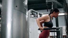 Focused fitness professional executing precise triceps dips on parallel bars, demonstrating strength and dedication within modern gym training environment - Powered by Shutterstock - Get 15% off with code: PIKWIZARD15