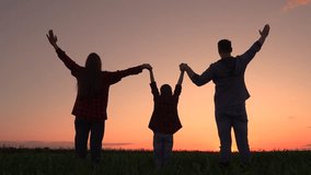 Dad mom child son raise their hands to sky together. Family kid raises their hands in wheat field, sunset. Group of people teamwork field. Happy family in countryside. Parents child boy holding hands - Powered by Shutterstock - Get 15% off with code: PIKWIZARD15