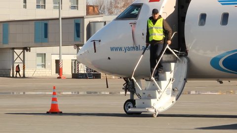 UFA, RUSSIA - APRIL 16: Maintenance of aircraft at the airport. CRJ-200 aircraft, the airline Yamal board VP-BBE on April 16 2013 in UFA, Russia. 